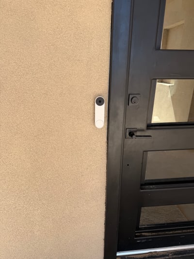 Video doorbell positioned beside a modern Rio Rancho entry door
