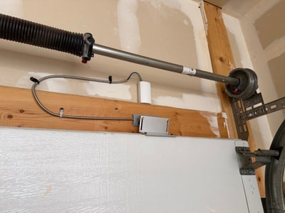 Camera power hardware mounted neatly along garage framing