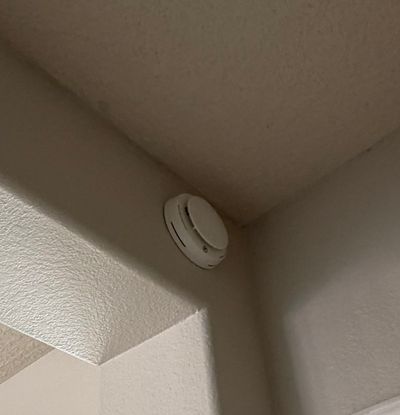 Installed life-safety detector in a ceiling corner